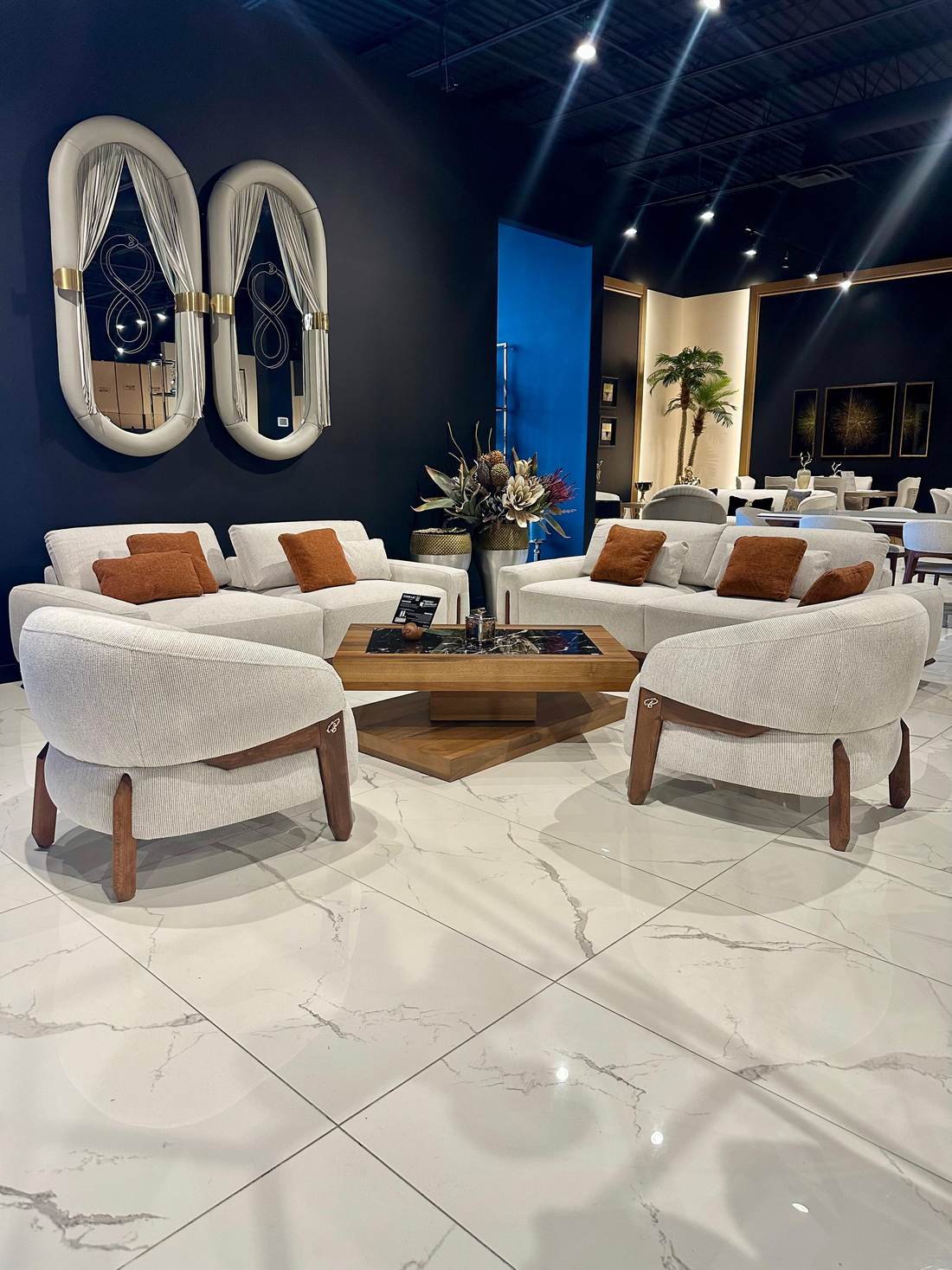 Sofas, armchairs and a coffee table staged in a furniture store showroom