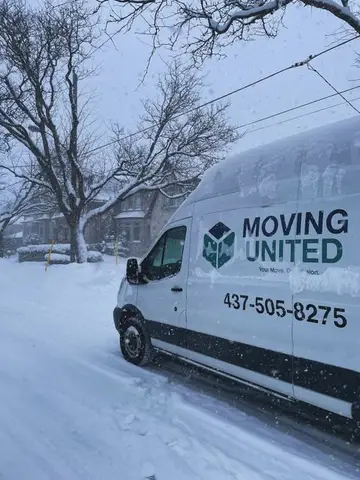 The Moving United van parked on a snowy Toronto street